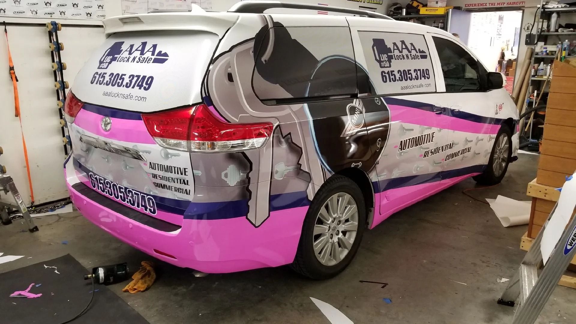 AAA Lock N Safe wrapped service vehicle inside the shop.
